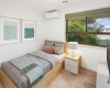 Bedoom with large window and air conditioning