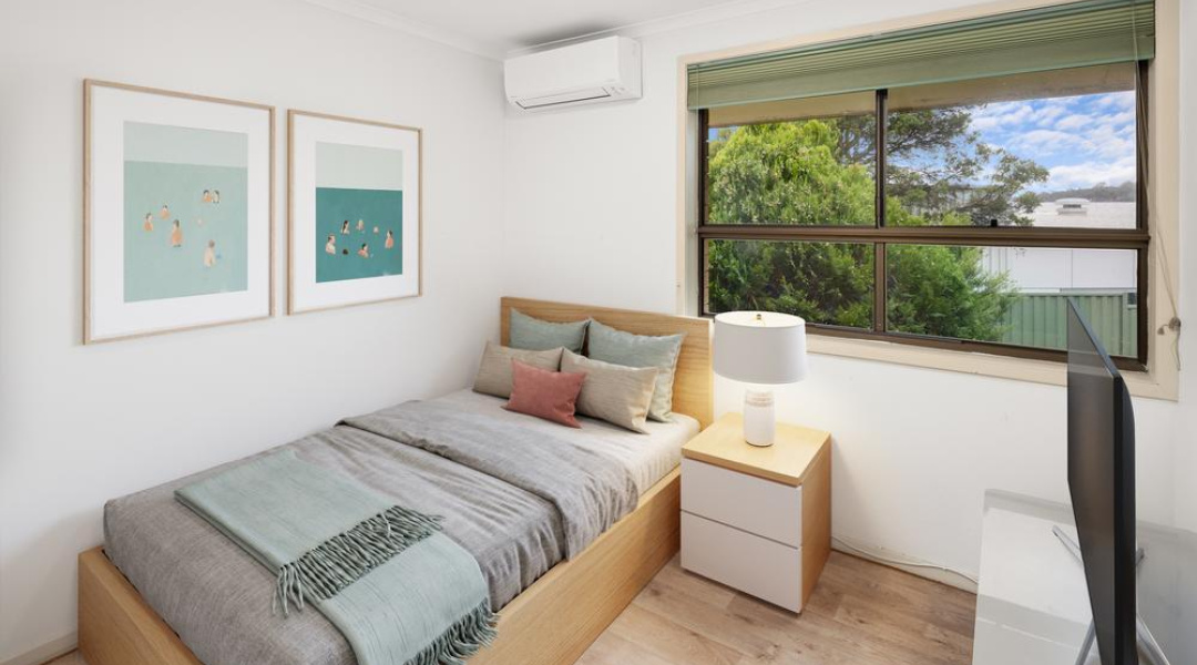 Bedoom with large window and air conditioning